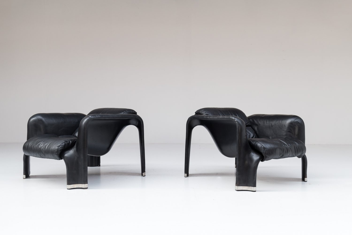 Pair of black leather Pohjola chairs by Pekka Perjo for Haimi Finland.